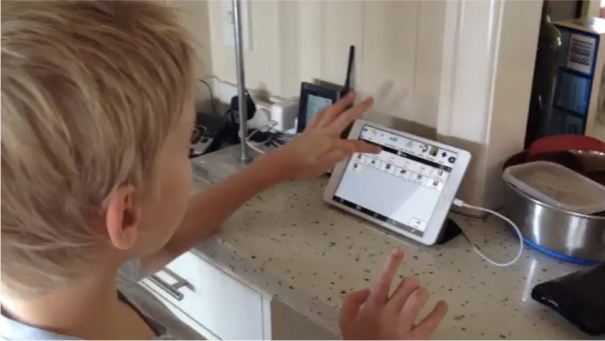 Young boy using AAC system on iPad with Proloquo2Go