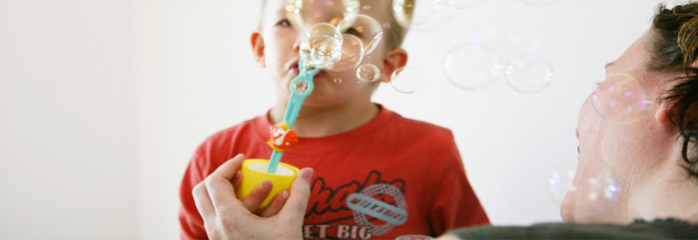 Young boy getting help for speech impediment with bubbles