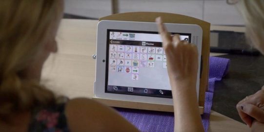 Fille pointant du doigt l’iPad avec Proloquo2Go