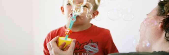 Young boy getting help for speech impediment with bubbles