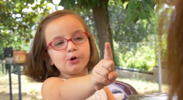 Five year old girl pointing finger