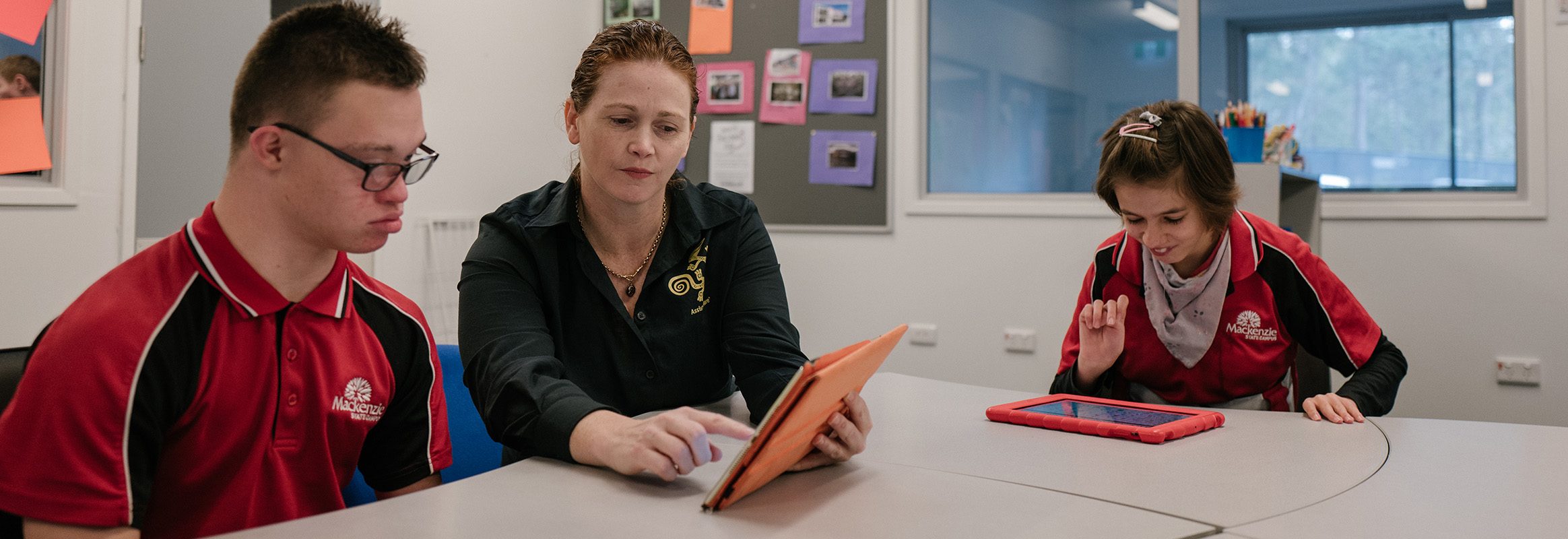 People sitting round a table using iPads