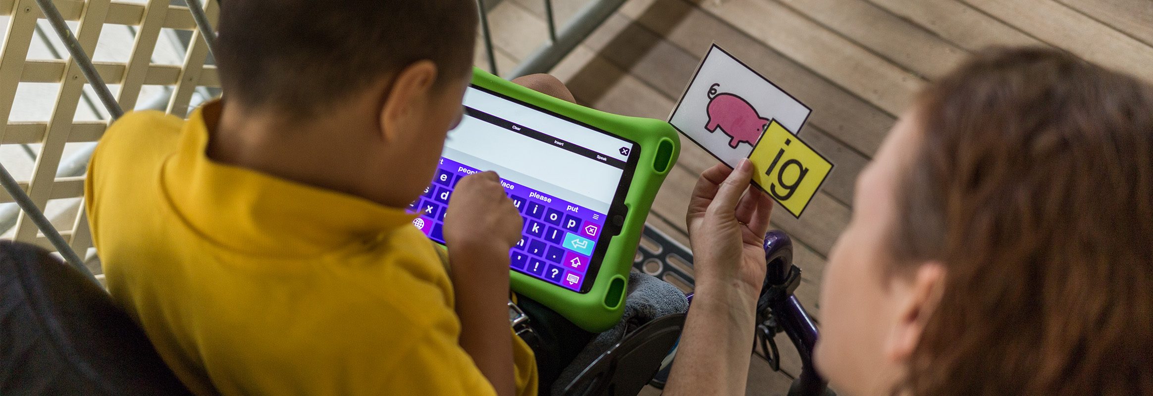 Young boy communicating using iPad with AAC system