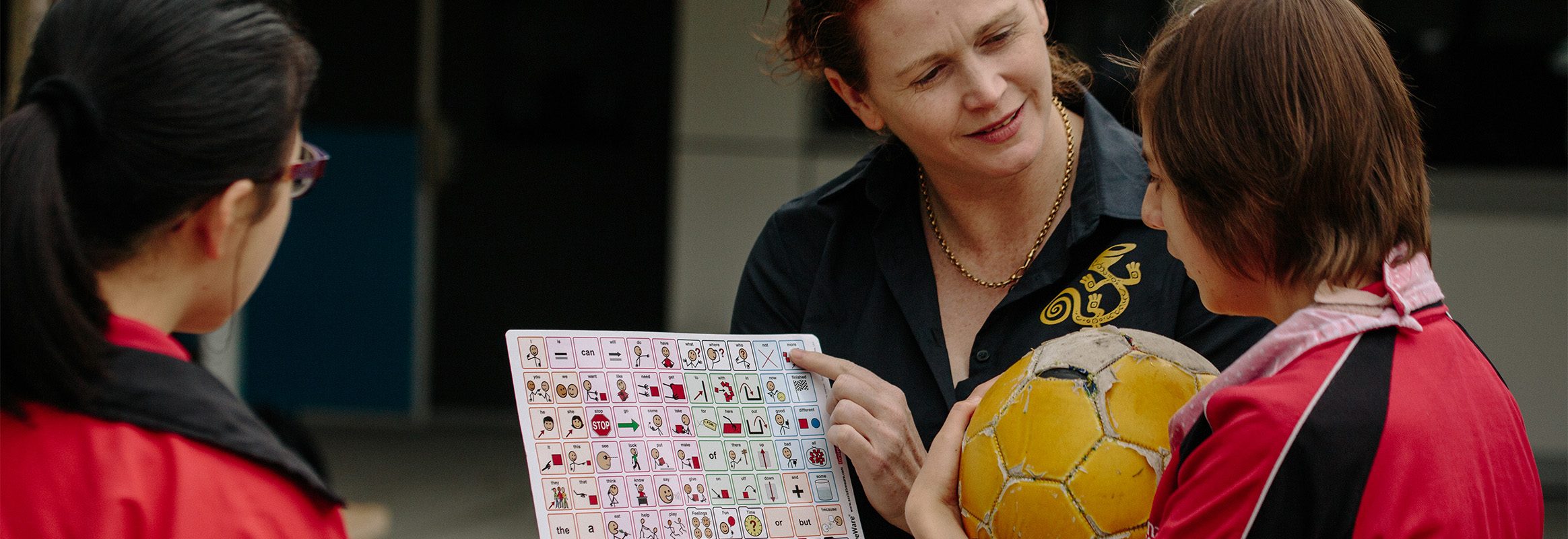 Teacher pointing at core words board