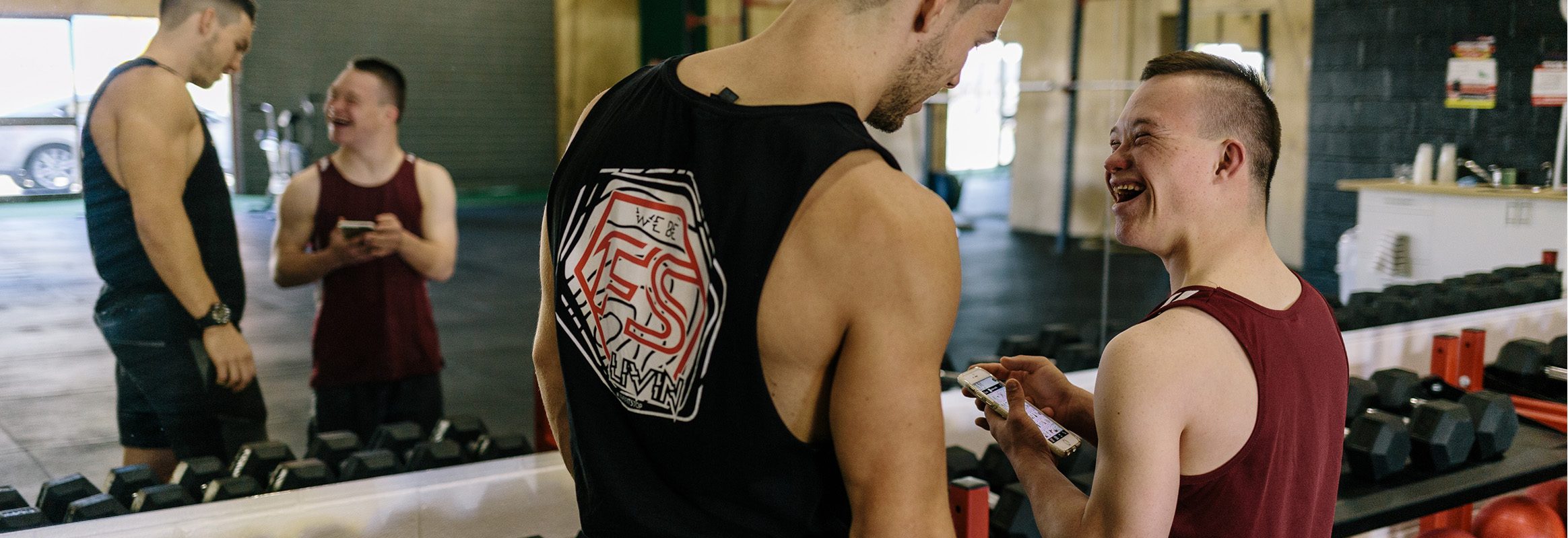 Two boys smiling in gym