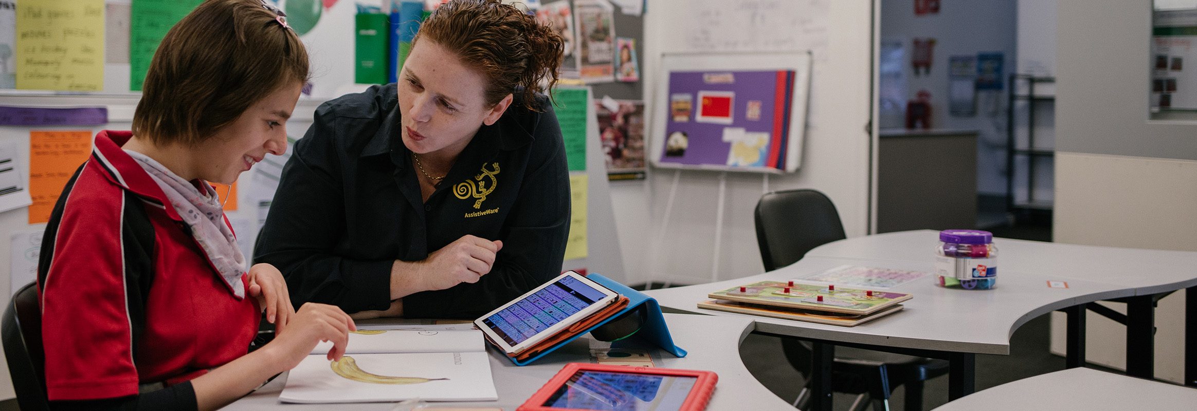 Teenager learning AAC using iPad with teacher