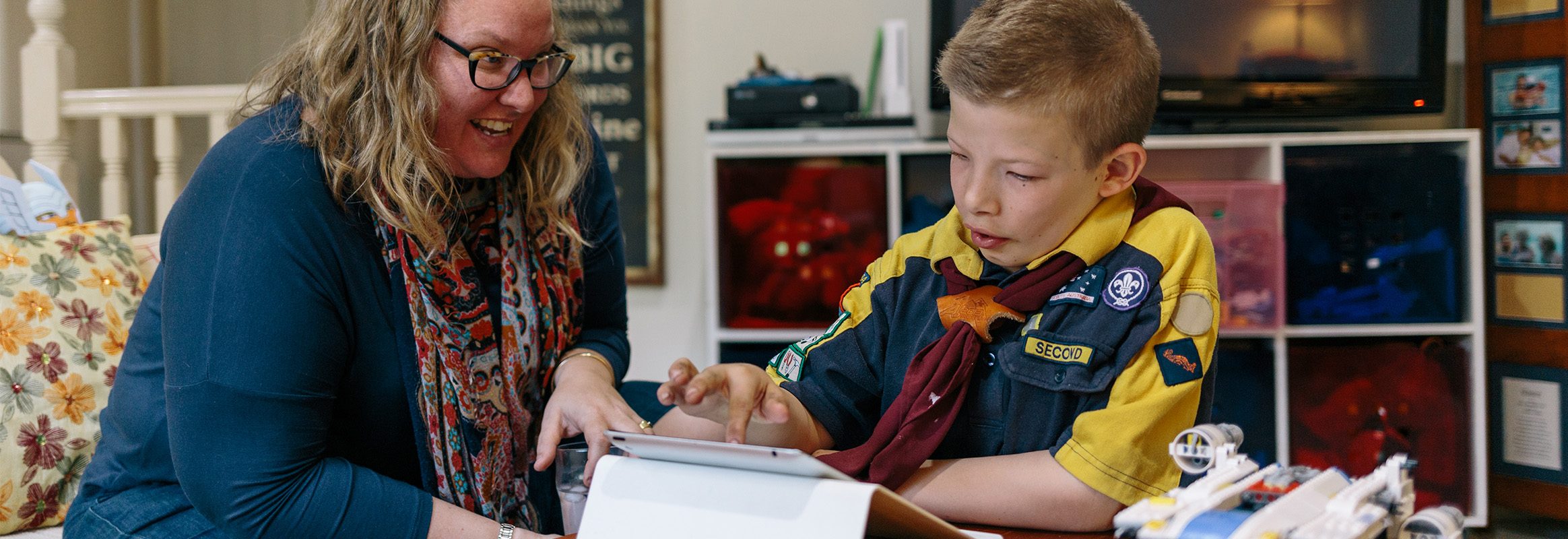 Young boy learning with iPad with his mother