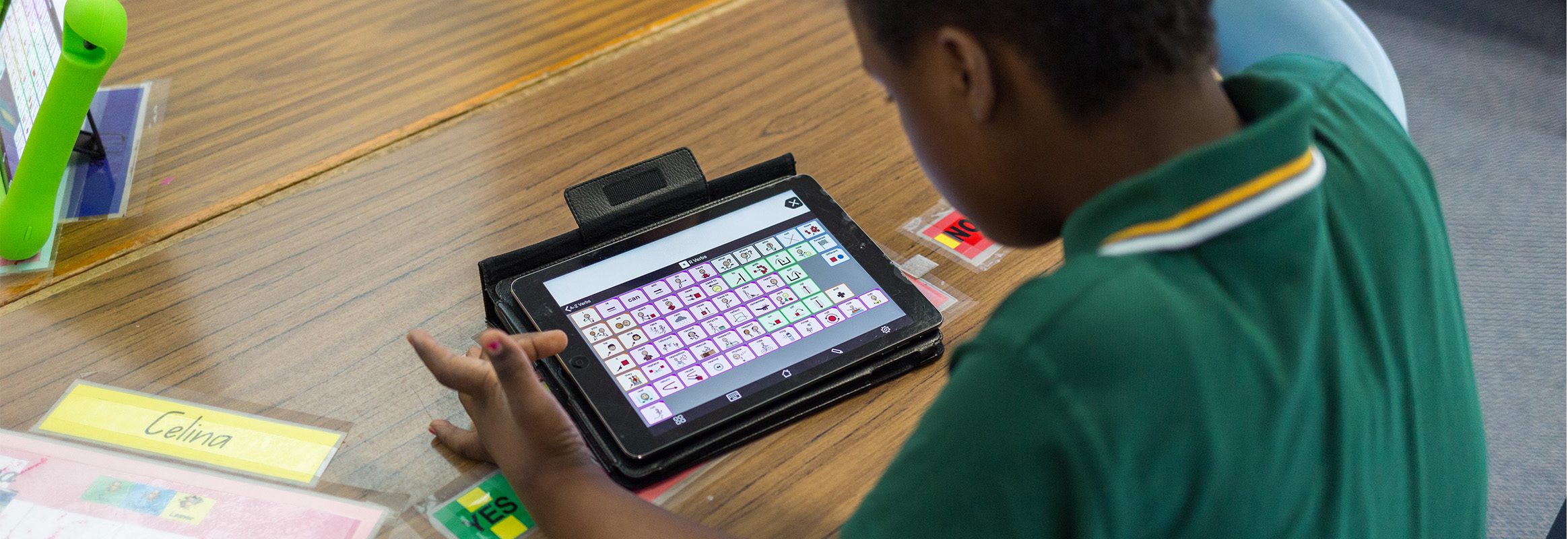 Young boy typing on iPad