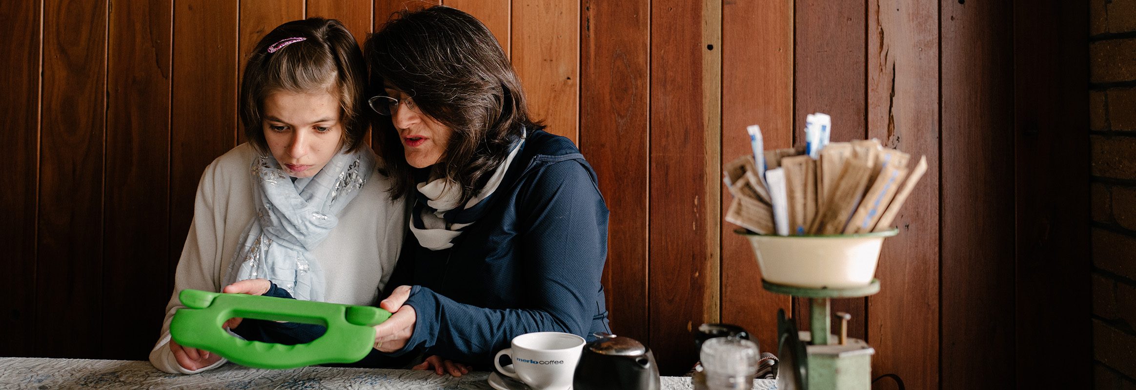 Young girl with teacher using iPad