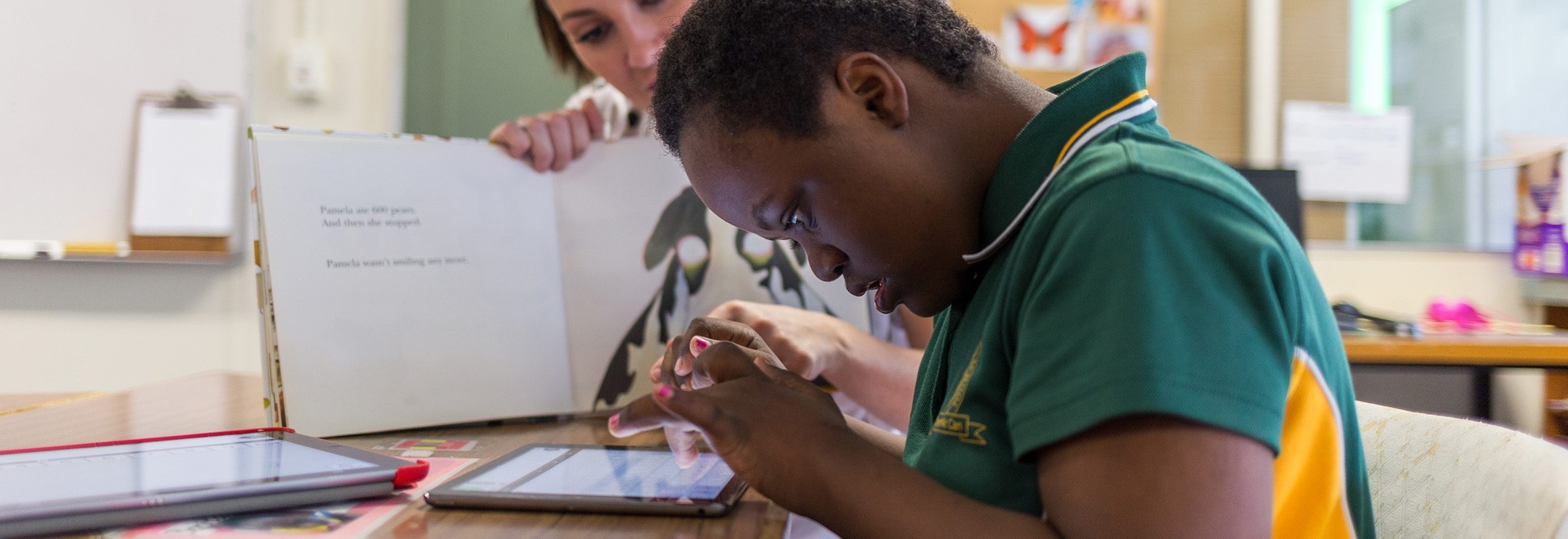 Young boy typing on iPad