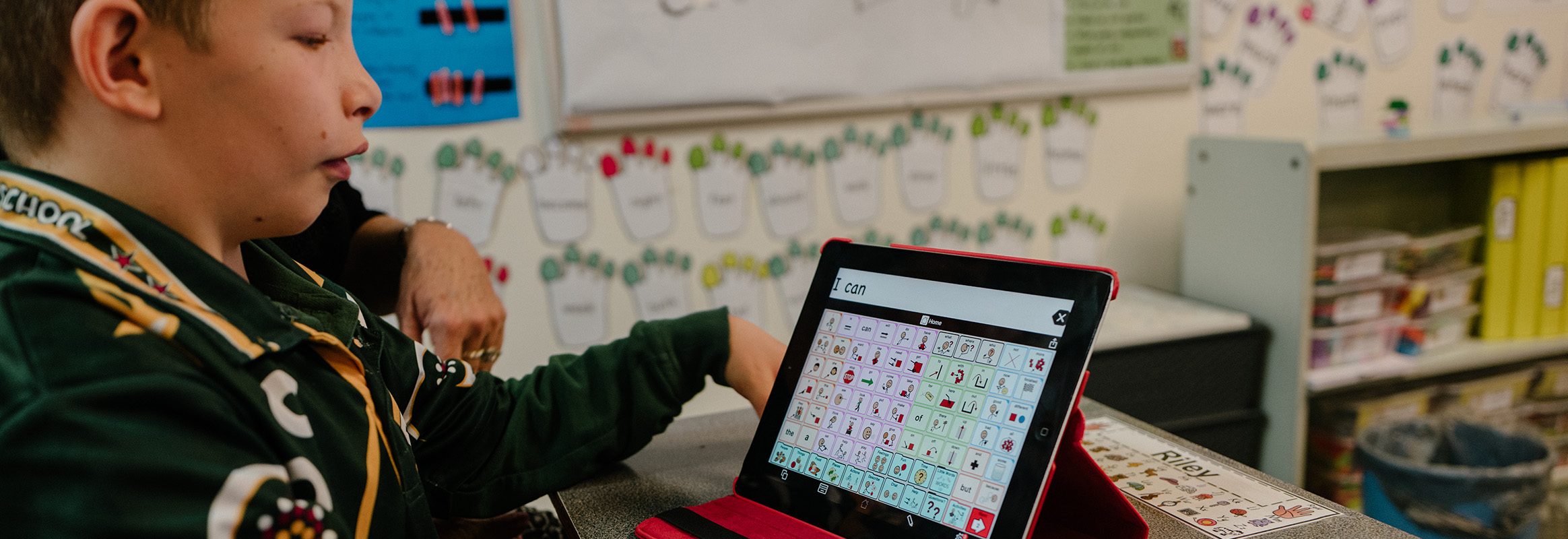 Young boy in classroom learning with iPad AAC System