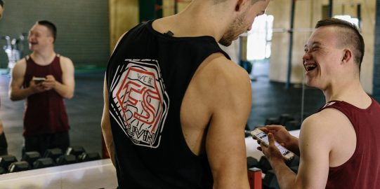 Two boys smiling in gym