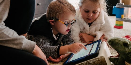 Young boy typing on iPad