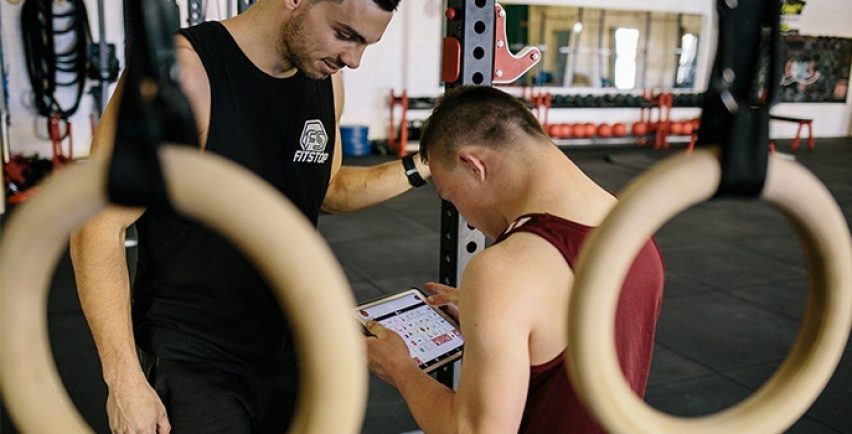 Tom using Proloquo2Go at the gym