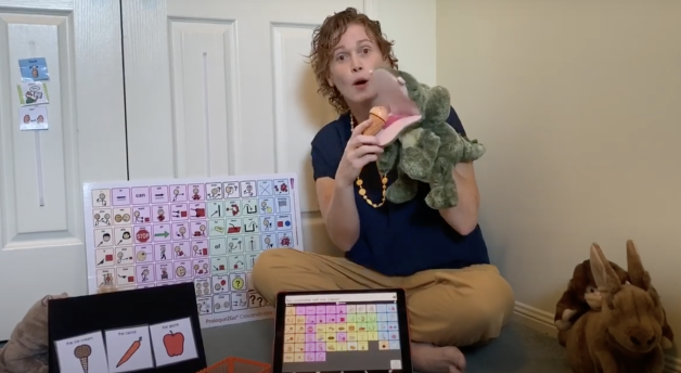 Amanda playing with puppets and AAC