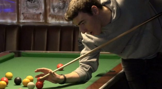Ben plays pool with a mate