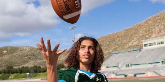 Teen boy playing football