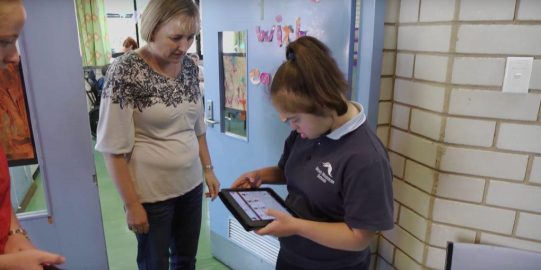 Danica using Proloquo2Go on iPad to communicate with teacher