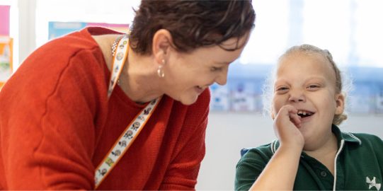 Amanda and student having fun in the classroom