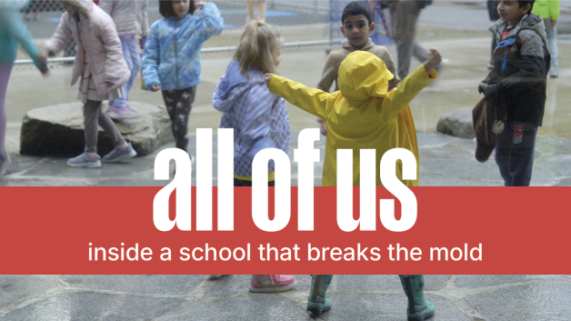 The poster shows a photograph of children on the playground, where the main focus is on a child in a yellow rain jacket facing their friends and jumping up with their hands high. The photograph has an overlay of text that say "all of us: inside a school that breaks the mold" with a red stripe behind the text.
