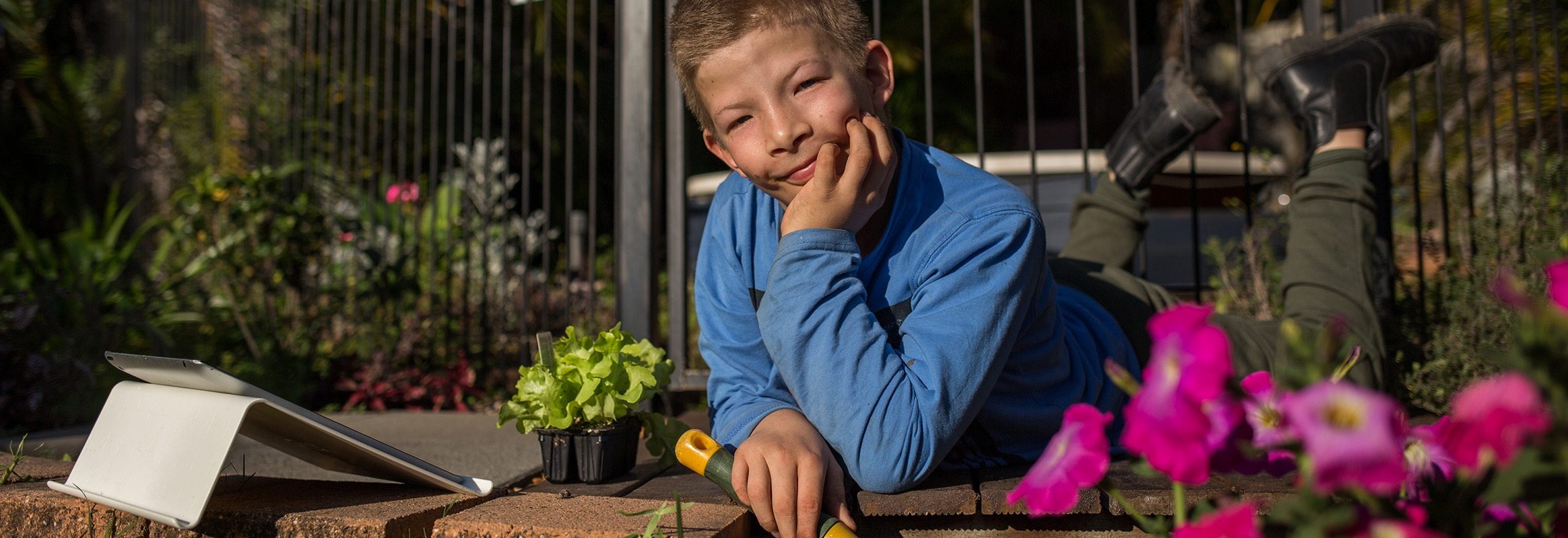 Boy in garden contemplating