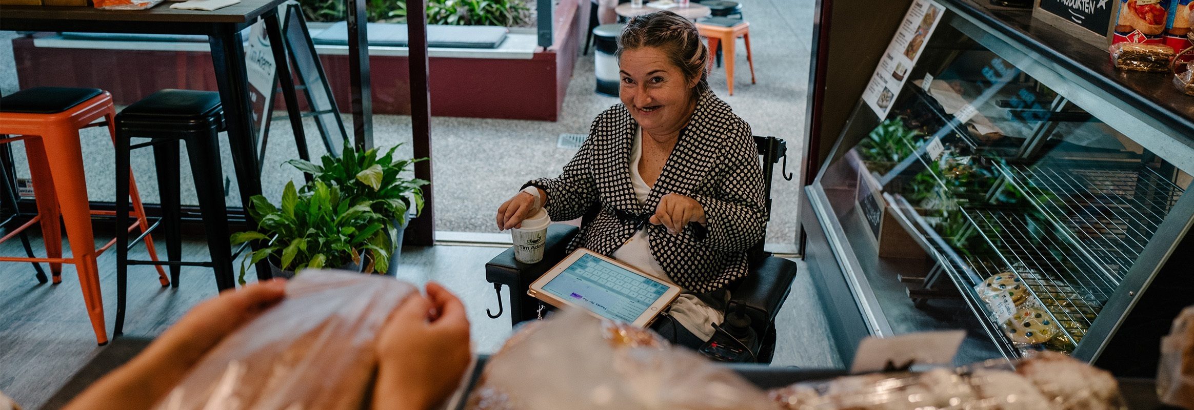 Lady in bakery ordering with iPad