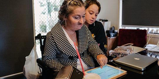 Lady talking with iPad with son 